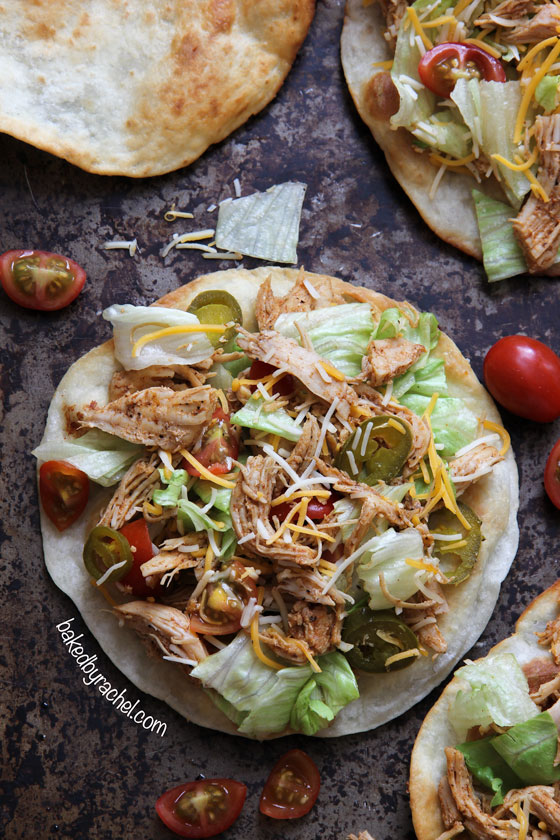 Loaded seasoned chicken tacos on a puffy fried tortilla. Recipe by @bakedbyrachel 
