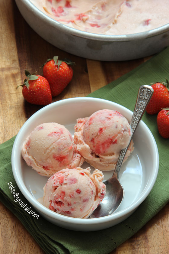Creamy homemade strawberry ice cream with fresh strawberry chunks throughout. Recipe at bakedbyrachel.com
