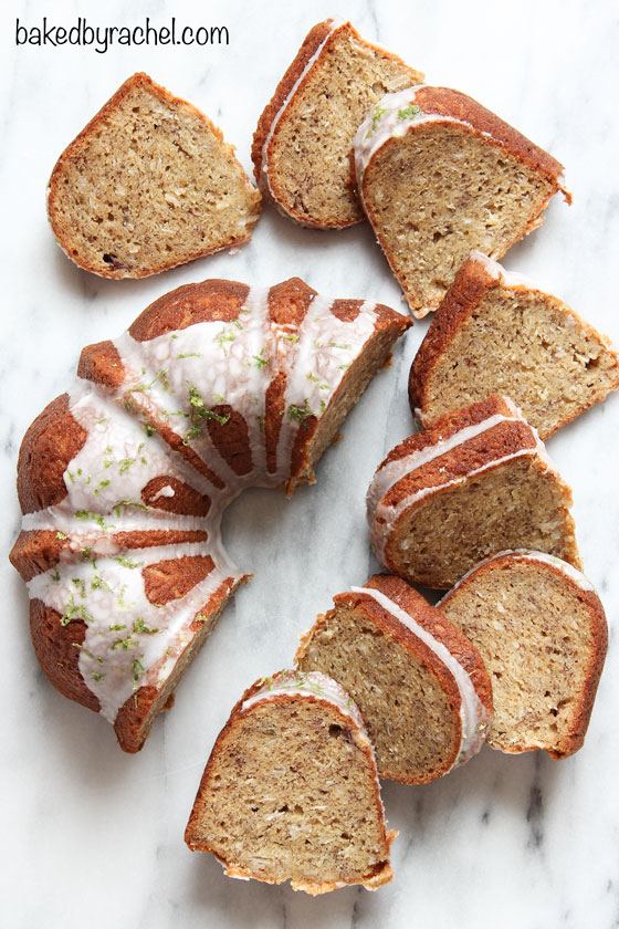 Moist banana bundt cake with sweetened coconut throughout and a tart lime glaze. Recipe from @bakedbyrachel