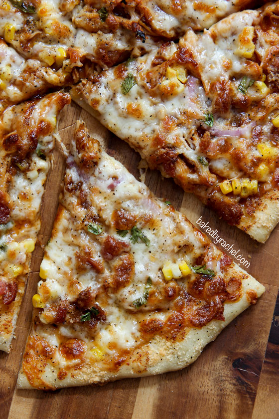Homemade thin crust barbecue chicken pizza with crispy bacon, fresh corn and onions. Recipe from @bakedbyrachel