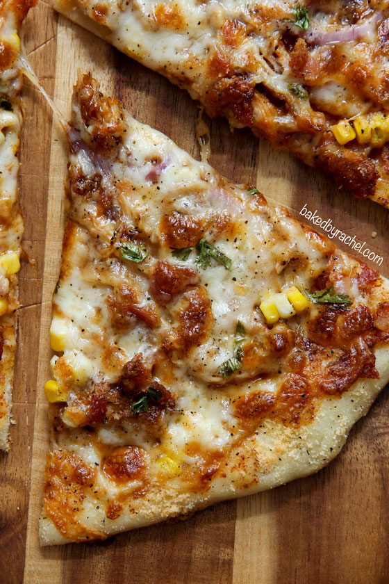 Homemade thin crust barbecue chicken pizza with crispy bacon, fresh corn and onions. Recipe from @bakedbyrachel