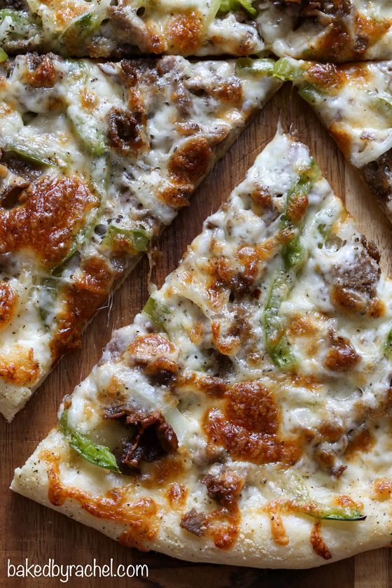 Three cheese thin crust cheesesteak pizza with green peppers and onions. Recipe from @bakedbyrachel
