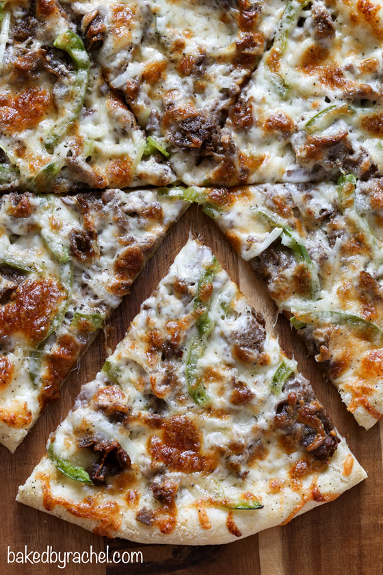 Three cheese thin crust cheesesteak pizza with green peppers and onions. Recipe from @bakedbyrachel