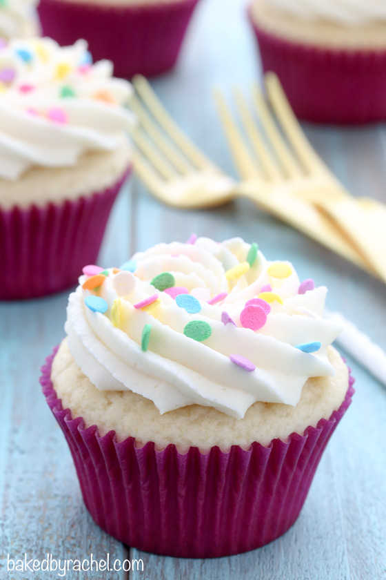 Moist white cupcakes with silky vanilla buttercream frosting recipe from @bakedbyrachel.  Perfect for birthdays and celebrations of all kinds!