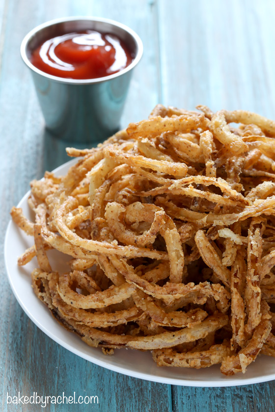 Easy homemade crispy fried seasoned onion strings recipe from @bakedbyrachel. A perfect topping for salads, burgers and more! 