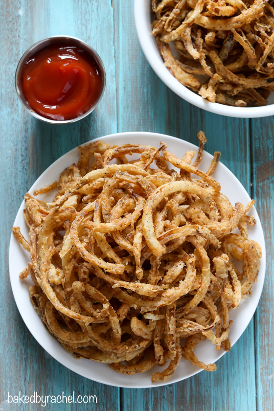 Easy homemade crispy fried seasoned onion strings recipe from @bakedbyrachel. A perfect topping for salads, burgers and more! 