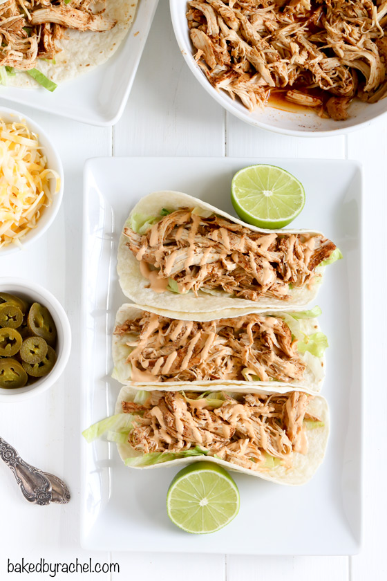 Easy slow cooker chicken tacos with spicy chipotle sour cream sauce recipe from @bakedbyrachel