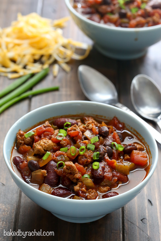 Sweet and spicy hearty slow cooker turkey and two bean chili recipe from @bakedbyrachel