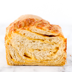 Soft and airy homemade braided cheddar beer bread recipe from @bakedbyrachel