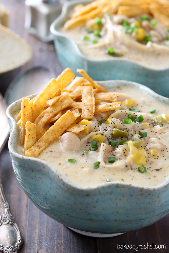 Slow cooker creamy white chicken chili with cheddar cheese recipe from @bakedbyrachel
