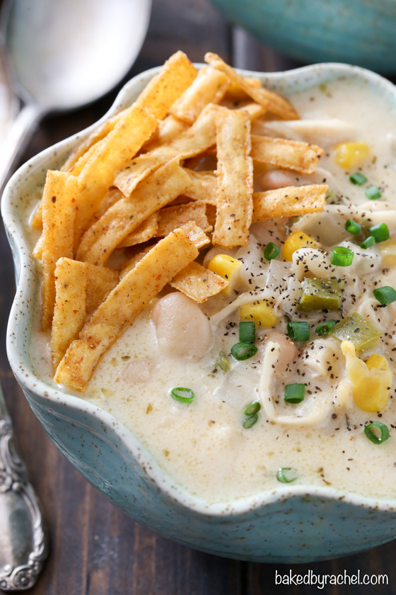 Slow cooker creamy white chicken chili with cheddar cheese recipe from @bakedbyrachel