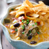 Slow cooker cheesy chicken tortilla soup recipe from @bakedbyrachel A comforting meal easy enough for any day of the week!
