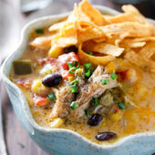Slow cooker cheesy chicken tortilla soup recipe from @bakedbyrachel A comforting meal easy enough for any day of the week!