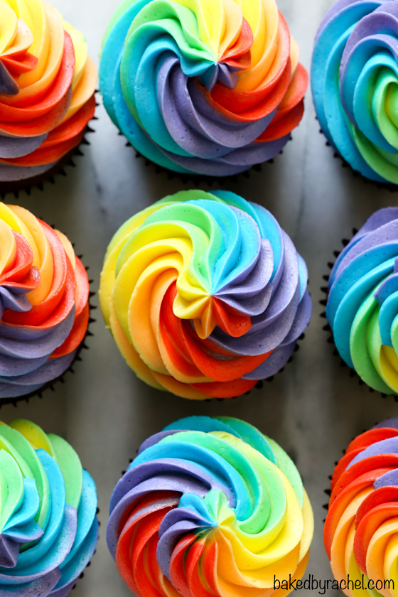 Moist homemade chocolate cupcakes with fluffy rainbow buttercream frosting recipe from @bakedbyrachel A fun and festive treat for St. Patrick's Day celebrations or any day of the year!