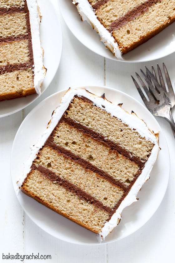 Layers of cinnamon graham cake with chocolate buttercream filling and coated in toasted marshmallow frosting.