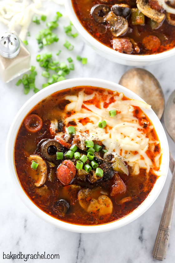 Super easy and comforting slow cooker pizza soup recipe from @bakedbyrachel This delicious soup features all of your favorite toppings from a traditional supreme pizza. A perfect meal to warm up with any night of the week and a fun addition to any game day menu!