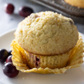 Moist and fluffy cranberry orange muffin recipe from @bakedbyrachel These easy homemade muffins are a fun seasonal treat, bursting with flavor from freshly squeezed oranges and tart cranberries. A perfect addition to any breakfast or brunch!