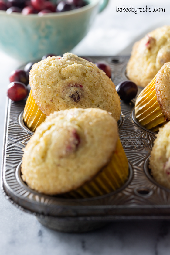 Moist and fluffy cranberry orange muffin recipe from @bakedbyrachel These easy homemade muffins are a fun seasonal treat, bursting with flavor from freshly squeezed oranges and tart cranberries. A perfect addition to any breakfast or brunch!